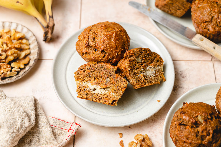 vegan carrot cake muffins on a plate, one cut in half