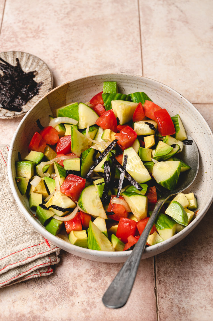 cucumber ponzu salad in a bowl with spoon