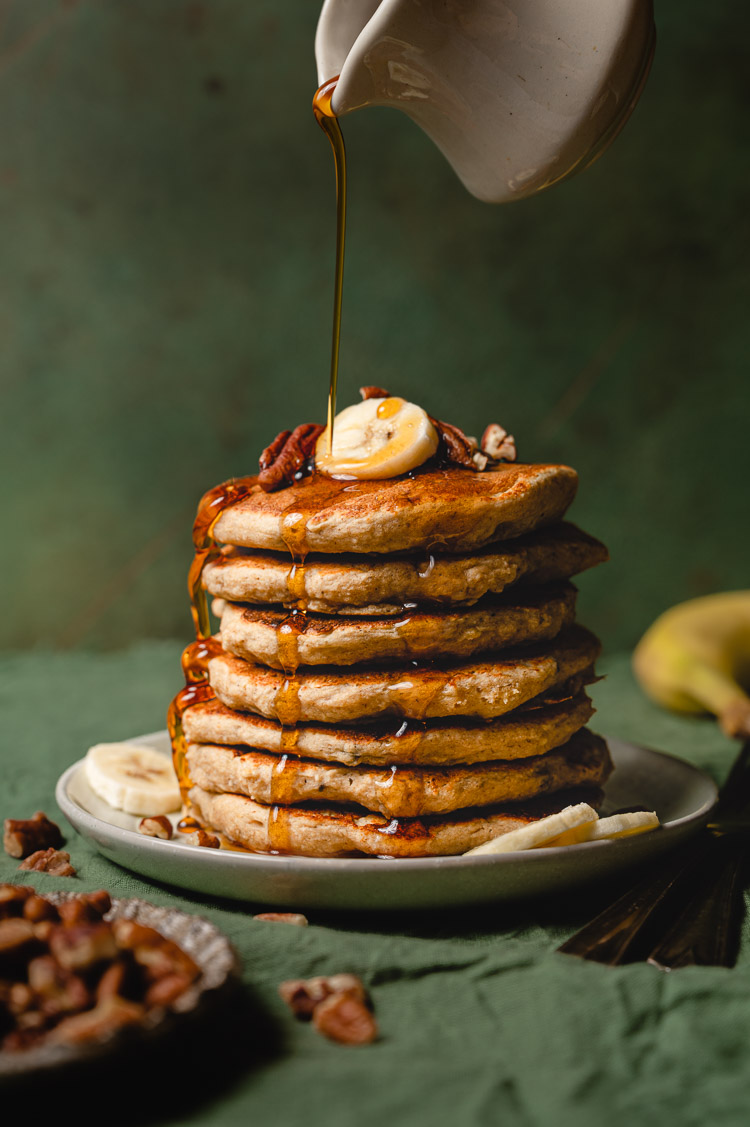 vegan banana oat pancake stack with maple syrup drizzle