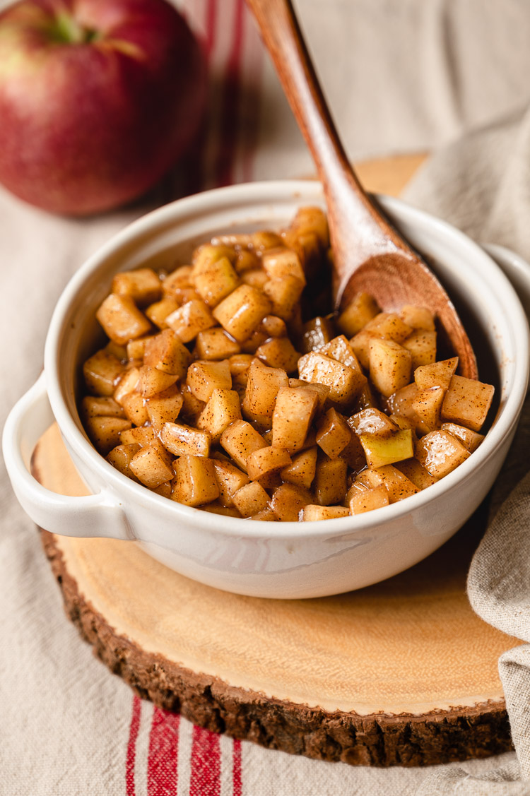 stewed apples in a bowl with a spoon