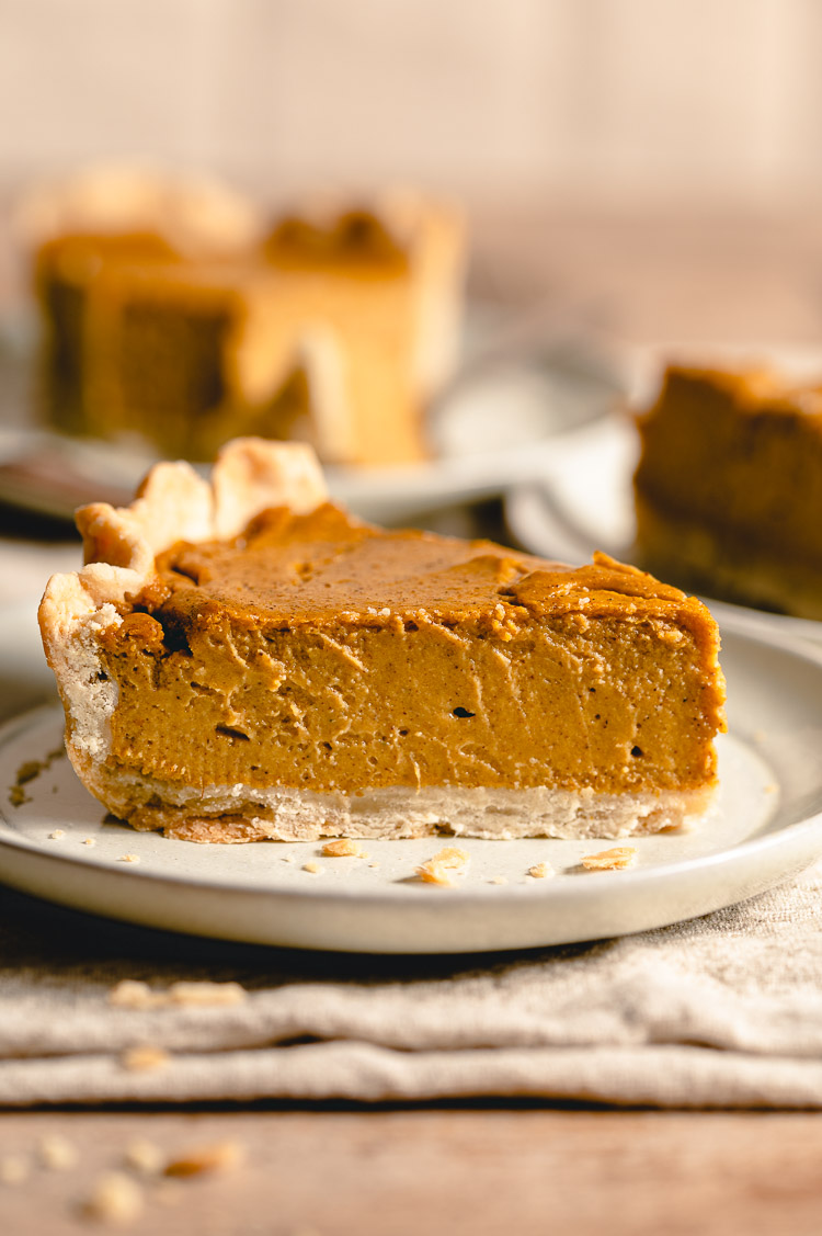 close up slice of tofu pumpkin pie on a plate