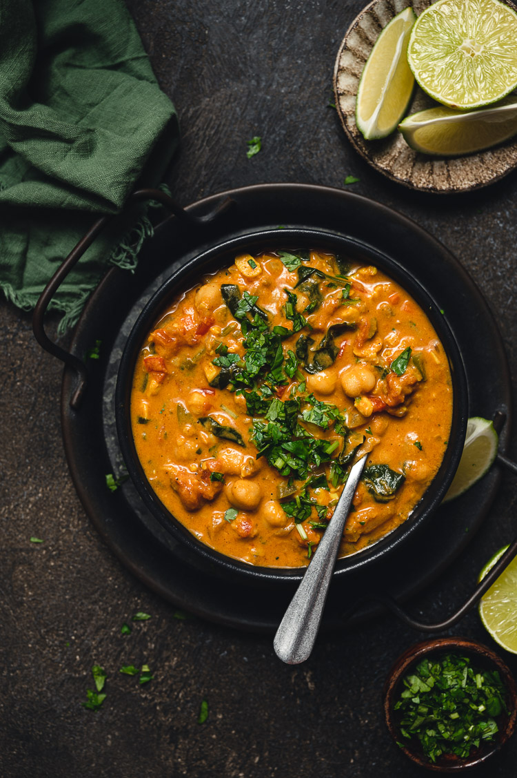 tempeh chickpea peanut curry in a bowl with spoon