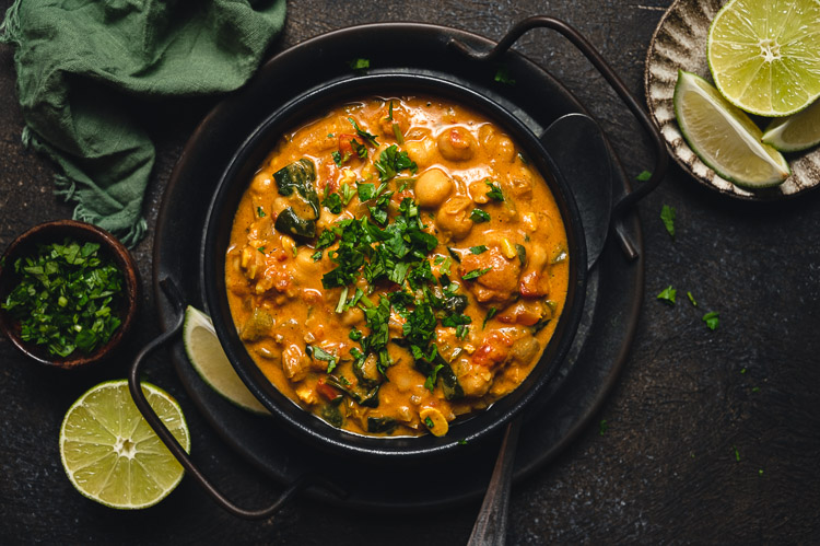 bowl of tempeh chickpea peanut curry on a platter