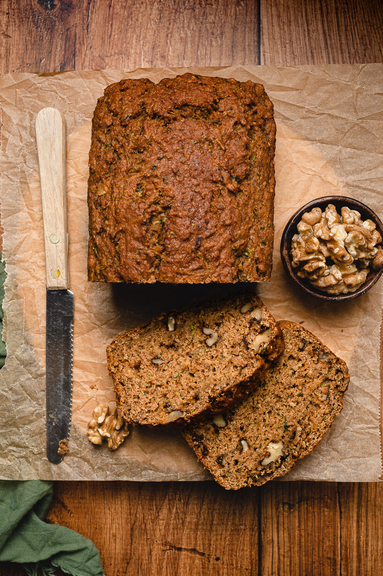 vegan zucchini bread sliced on a serving board