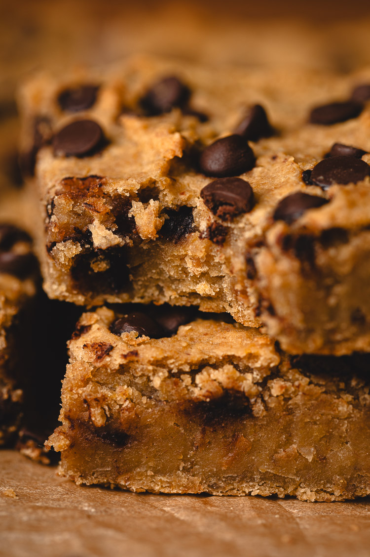 stack of chickpea blondies with a bite taken out of one