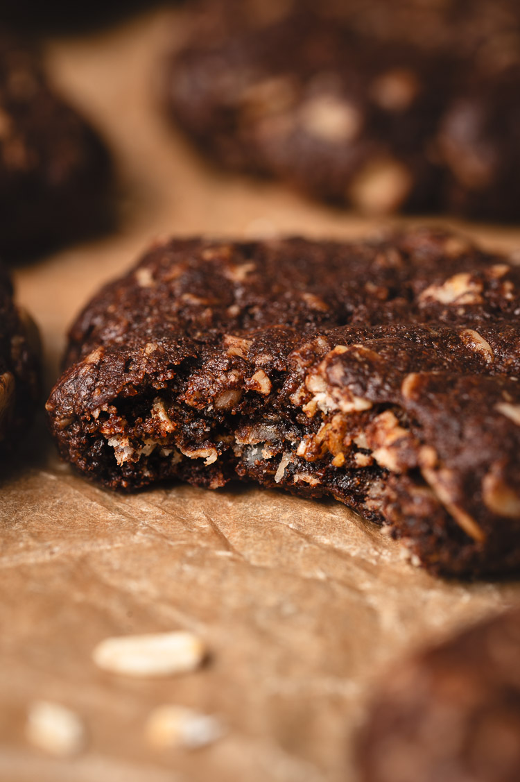 close up of chocolate oatmeal cookie with a bite taken out of it