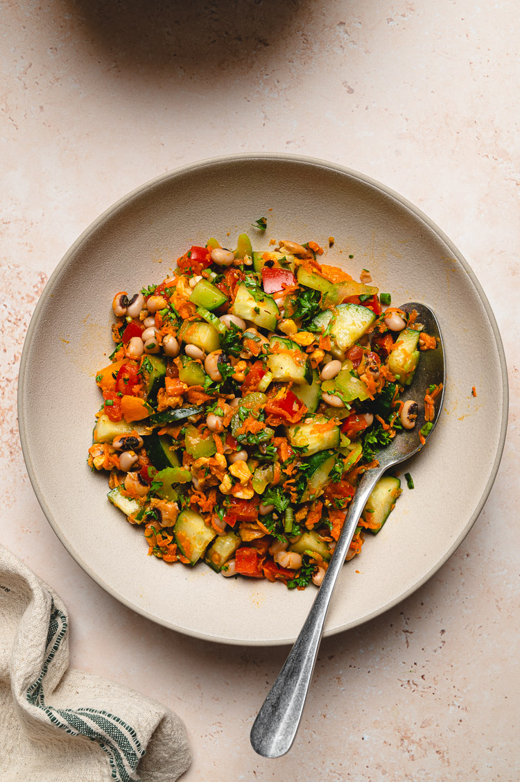 spiced bean salad in a bowl with a spoon