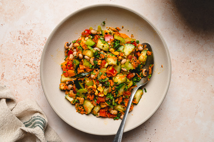 spiced bean salad in a bowl with spoon