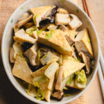 miso braised tofu in a serving dish on a tea towel