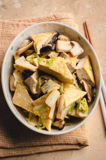 miso braised tofu in a serving dish on a tea towel