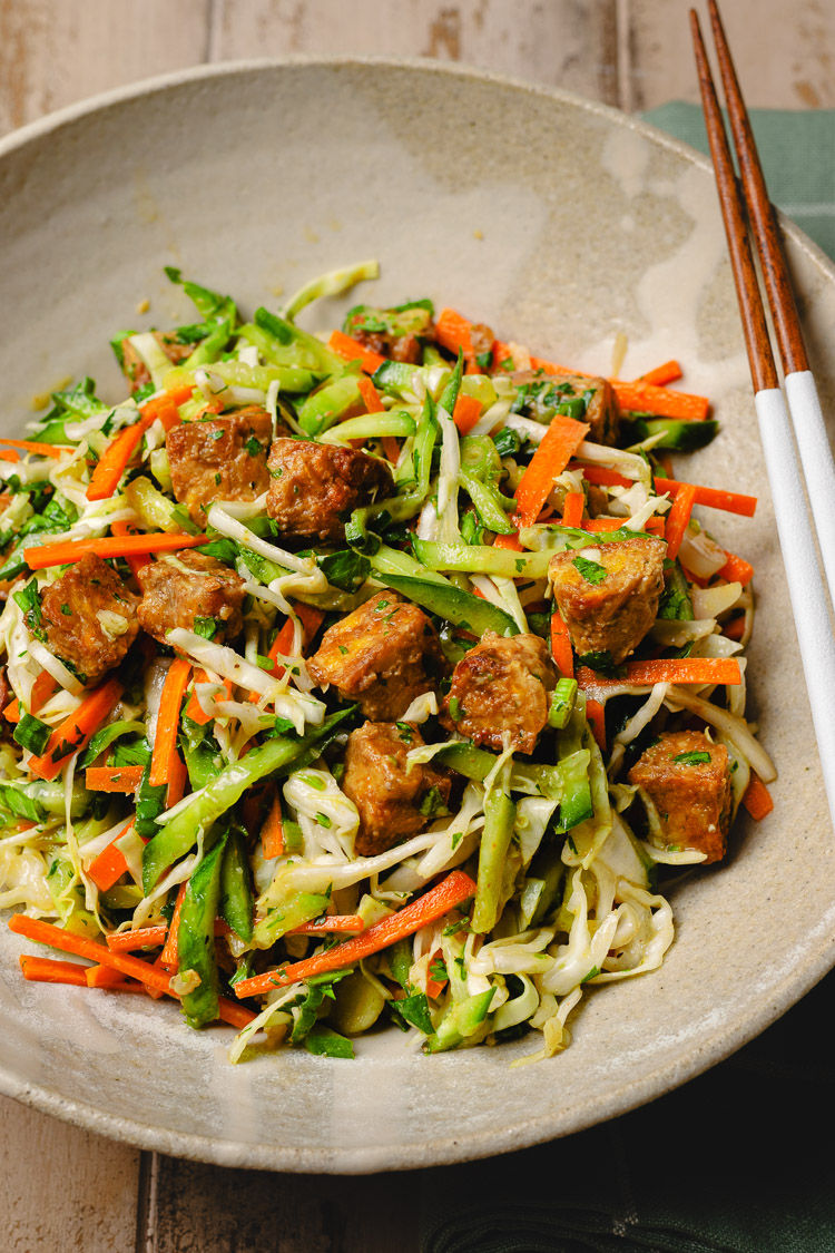 peanut tempeh salad in a bowl with chopsticks