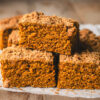 pumpkin coffee cake slices stacked on parchment paper