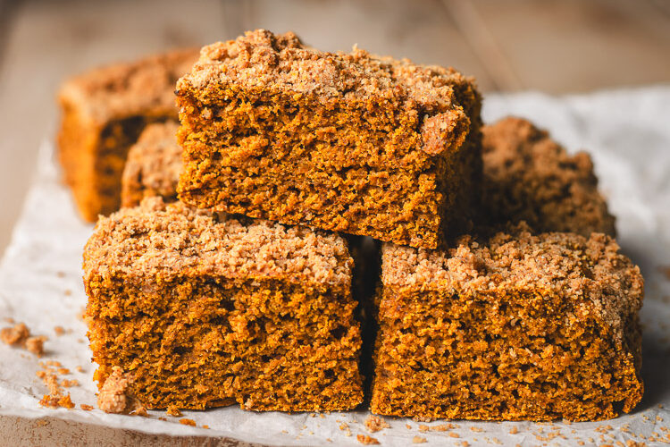 pumpkin coffee cake slices stacked on parchment paper