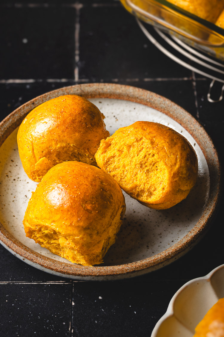 vegan pumpkin dinner rolls on a plate