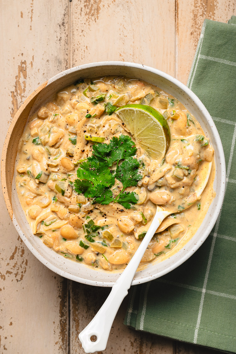 vegan white chili in a bowl with spoon