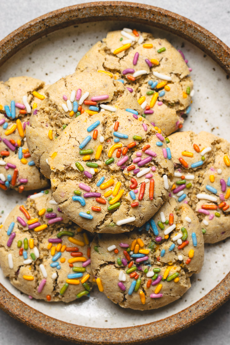 vegan funfetti cookies stacked on a plate