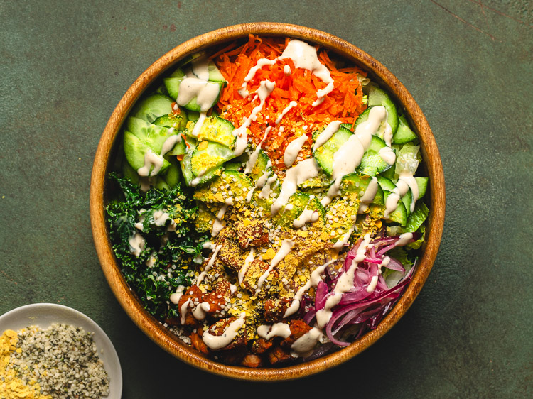 vegan kale caesar salad in mixing bowl