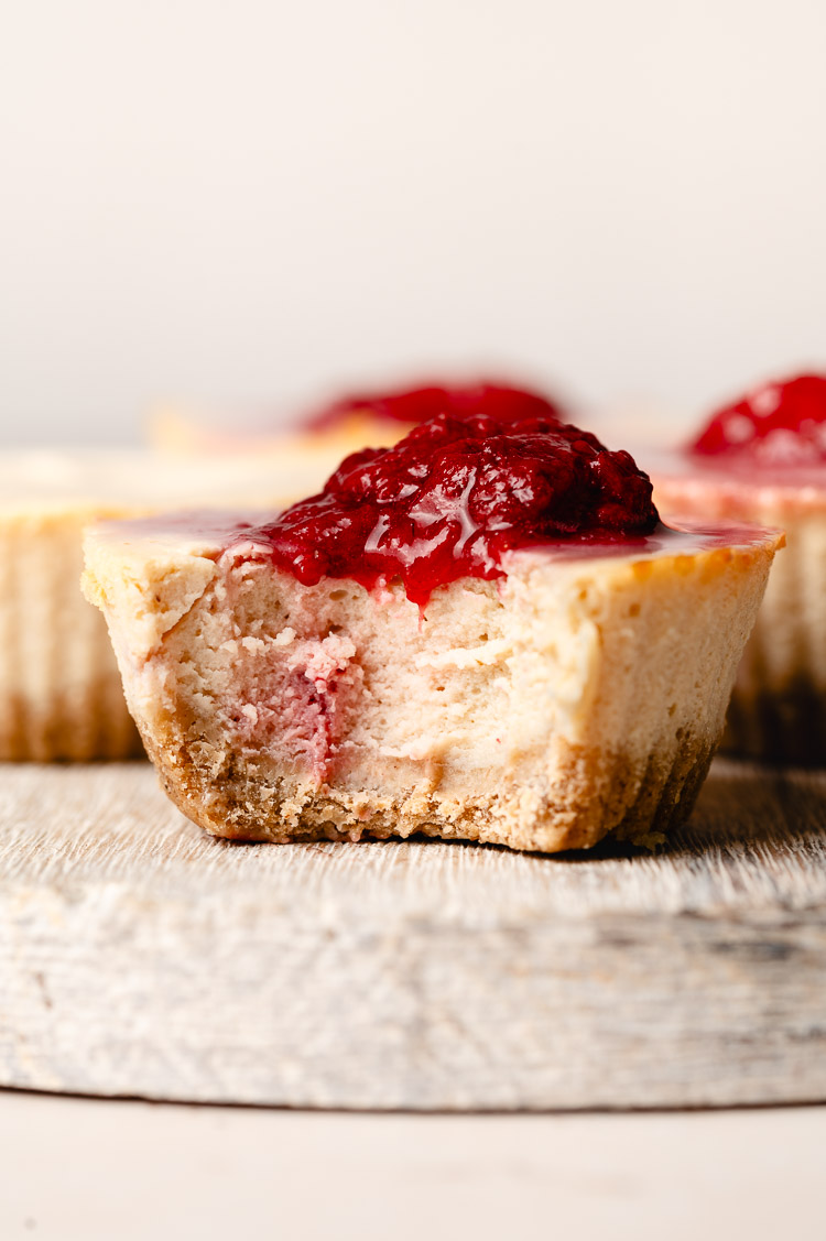 mini vegan cheesecake with a bite taken out of it