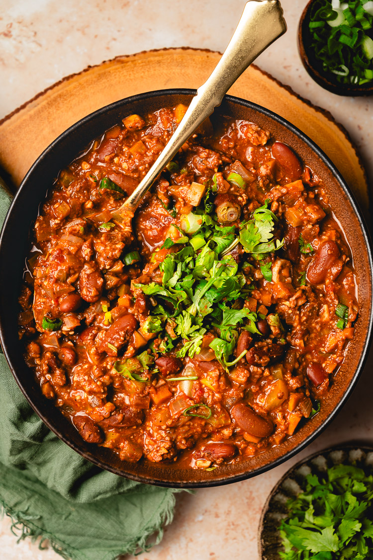bowl of meaty vegan chili with a spoon