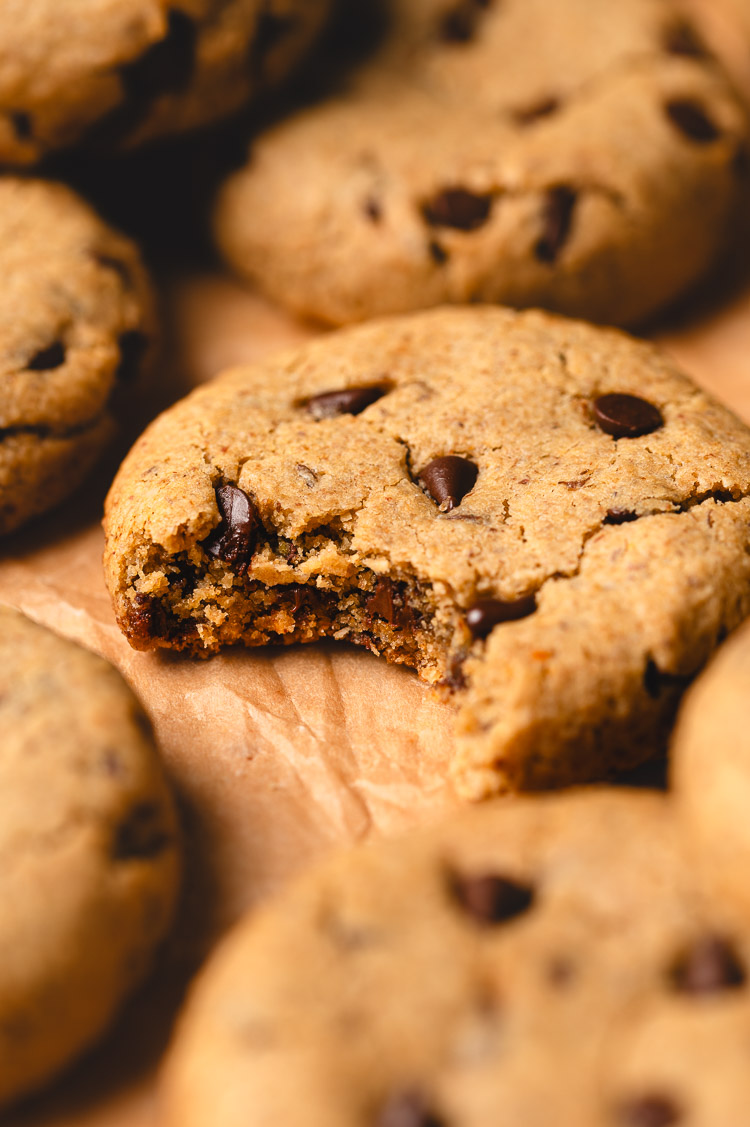 miso olive oil chocolate chip cookie with a bite taken out of it