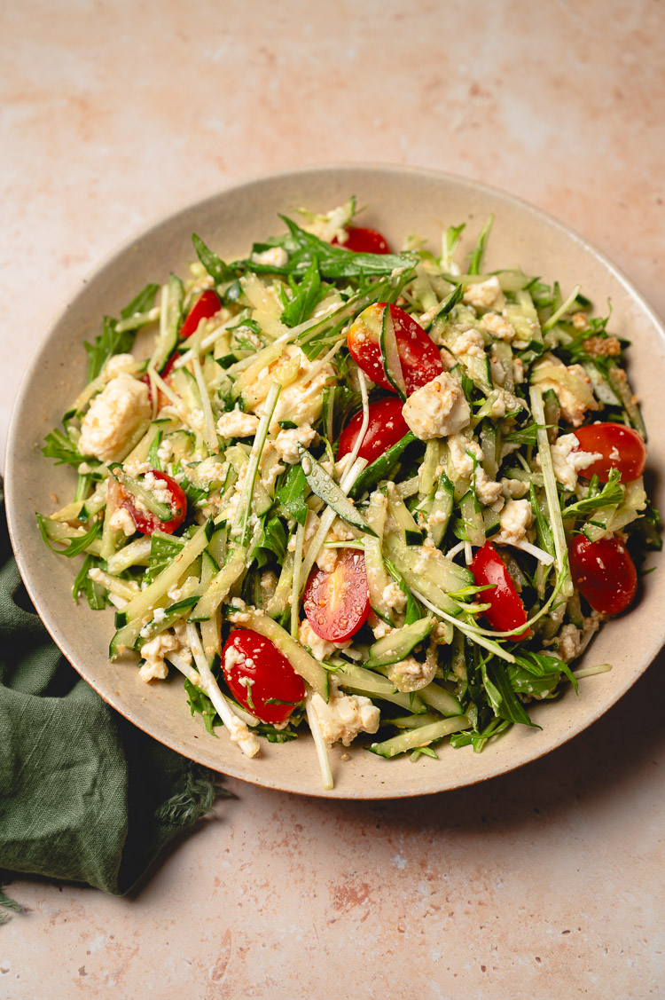 sesame mizuna salad on plate after tossing with dressing