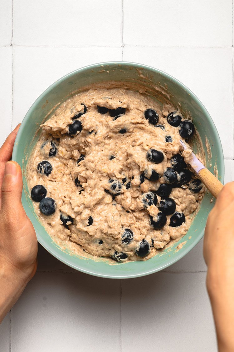 stirring blueberry oatmeal muffin batter