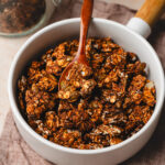 date sweetened granola in a bowl with spoon