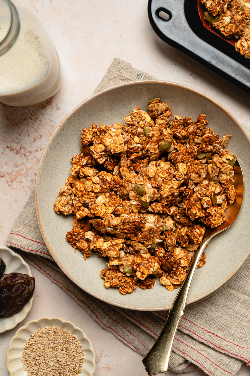 sesame miso granola in a bowl with spoon
